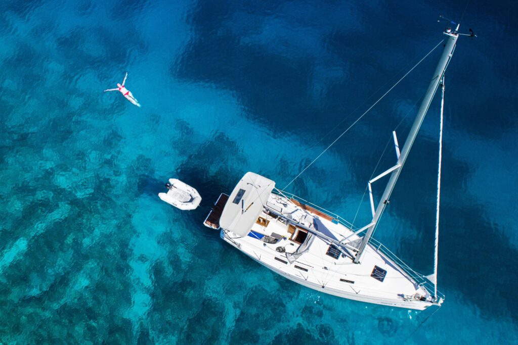 Boat and swimming woman and clear water - Salento Puglia