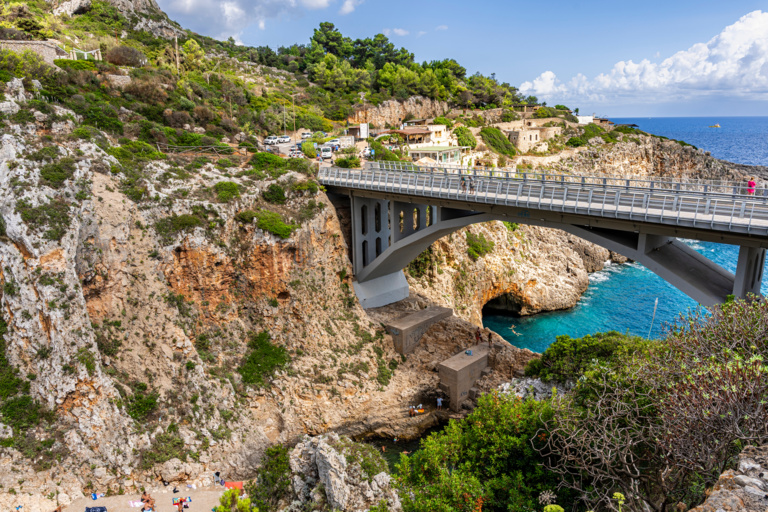 Scenic inlet called Ciolo, with bathers and a concrete bridge, in the municipality of Gagliano del Capo, province of Lecce, Salento area, Puglia region, Italy
