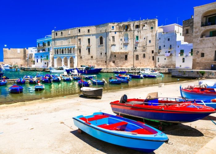 Traditional Italy - white town Monopoli with colorful fishinng boats in Puglia